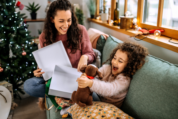mother and daughter opening presents on Christmas