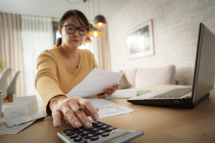 stressed woman calculating expenses